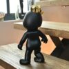 Jackelb figurine in black and gold on a stair