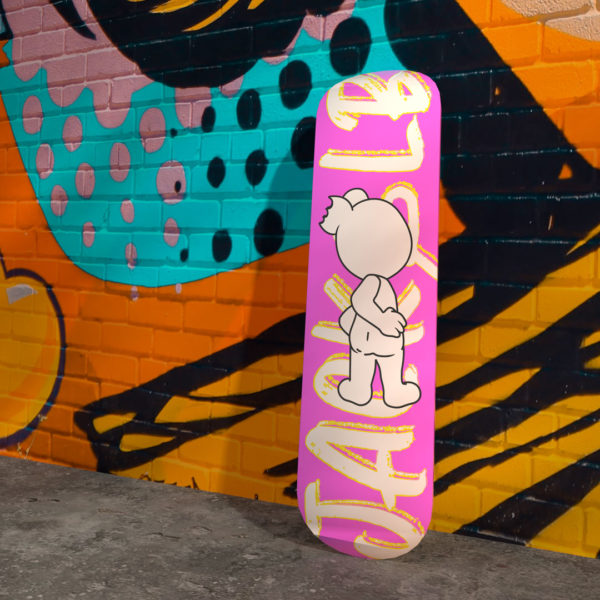 jack&lb pink skateboard against a street art wall