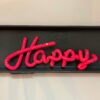 Happy Sign in pink on a wall arttoys accessories